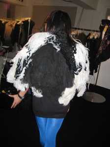 Kawai gets to try on an insane feathery cape. Mixed fabric of expensive feather, murano lace, tulle and with a felt lining. This pretty much spells the "fucking chaotic" philosophy for Reem.